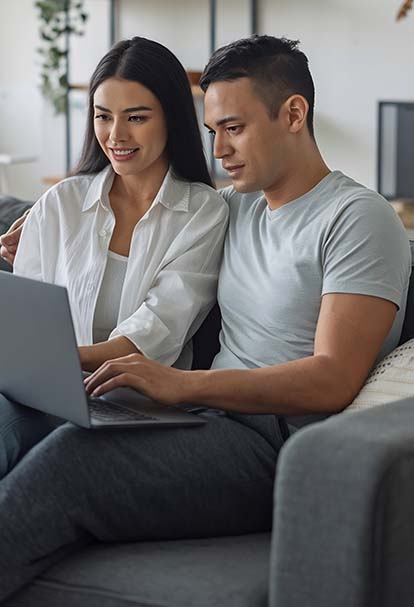Couple using laptop together for online therapy