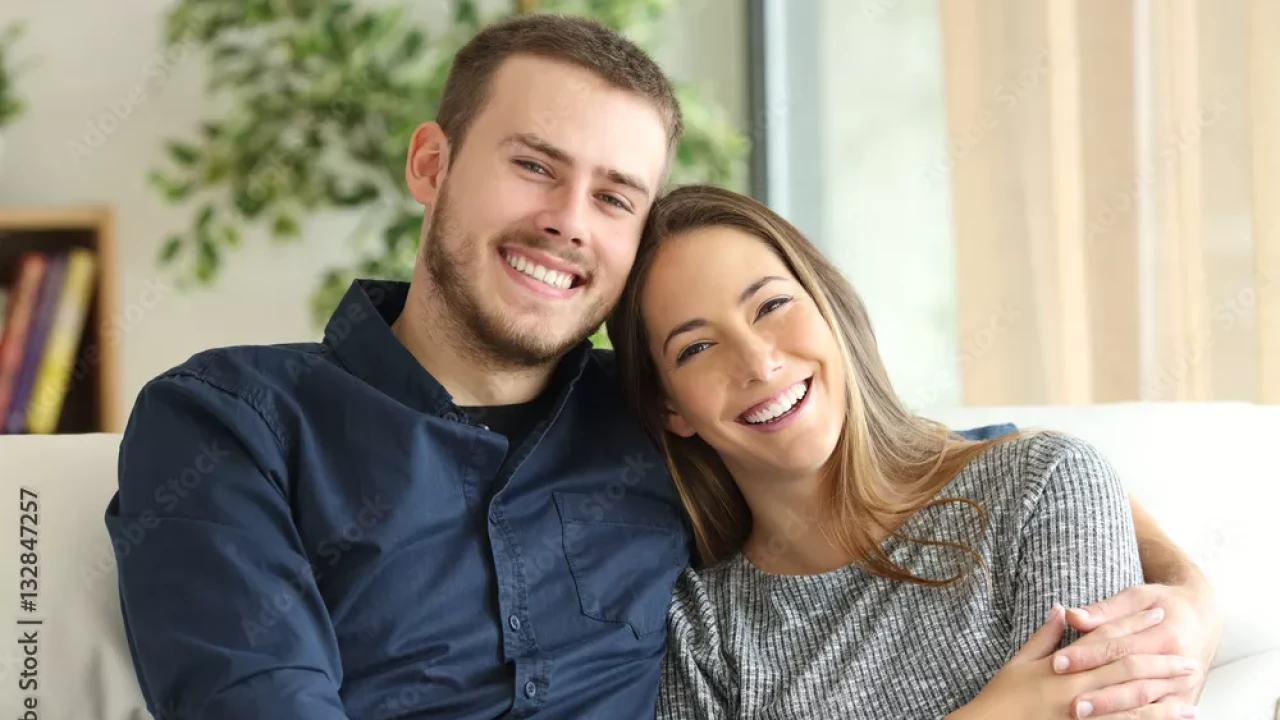 Smiling happy couple on a couch