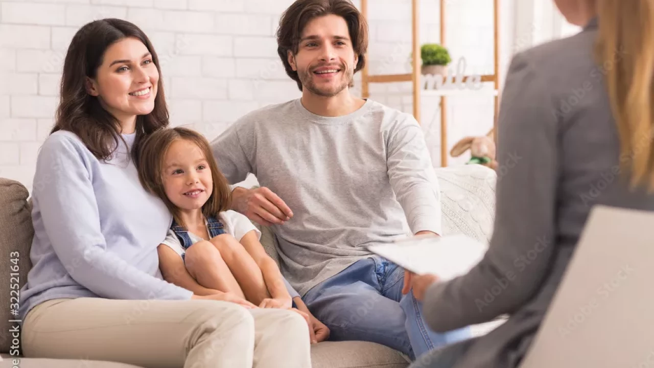 Parents sitting with their daughter talking to a therapist