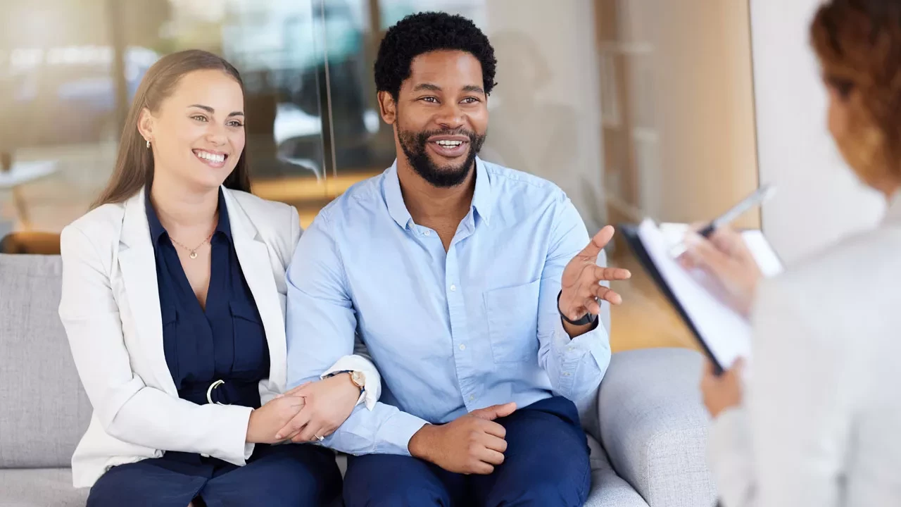 Newlywed couple smiling with their arms interlocked