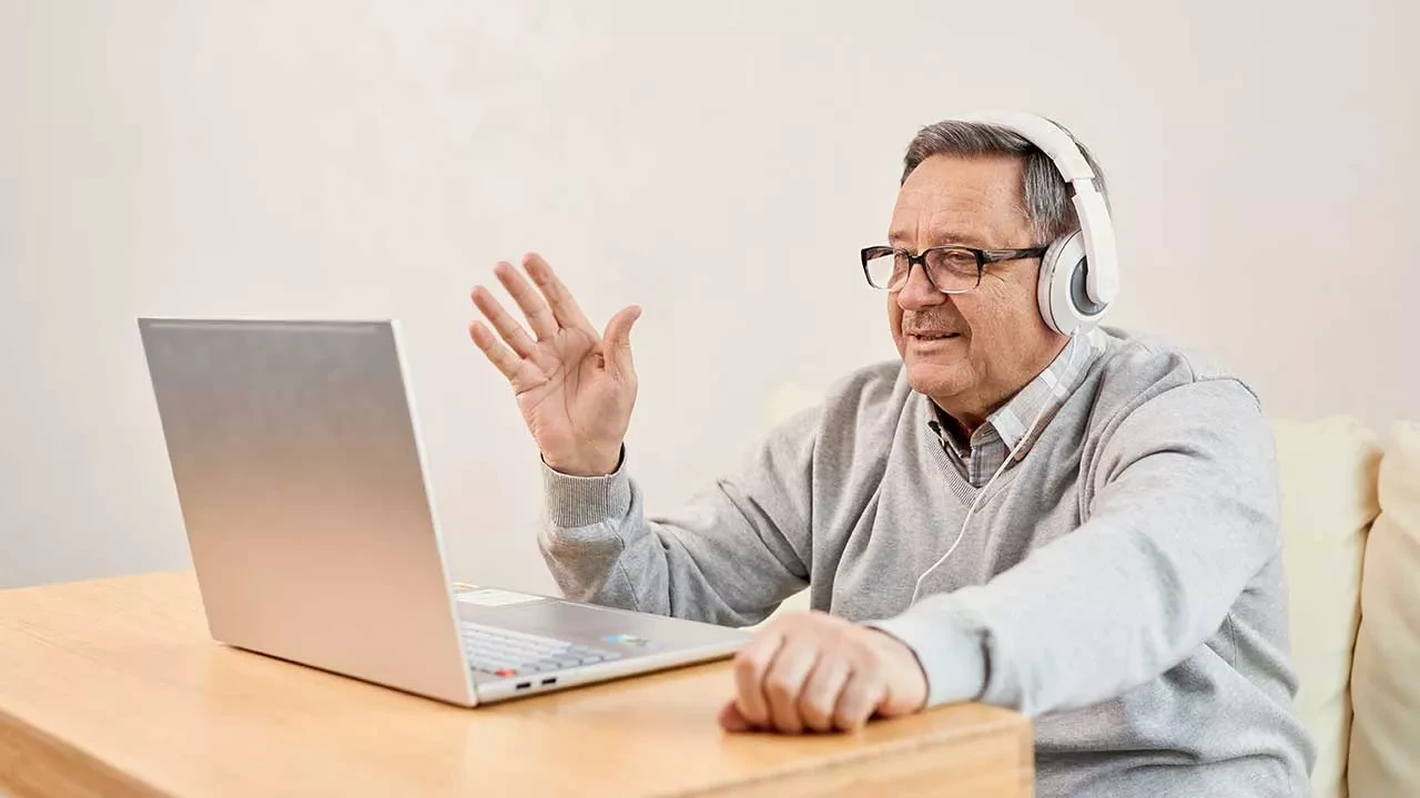 Older man wear headset for online therapy