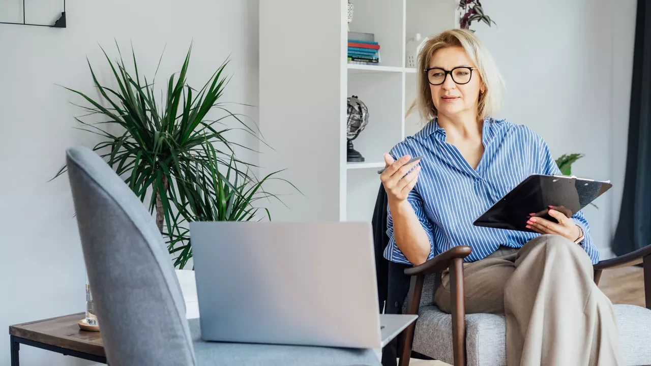 Woman in a blue shirt talking in an office