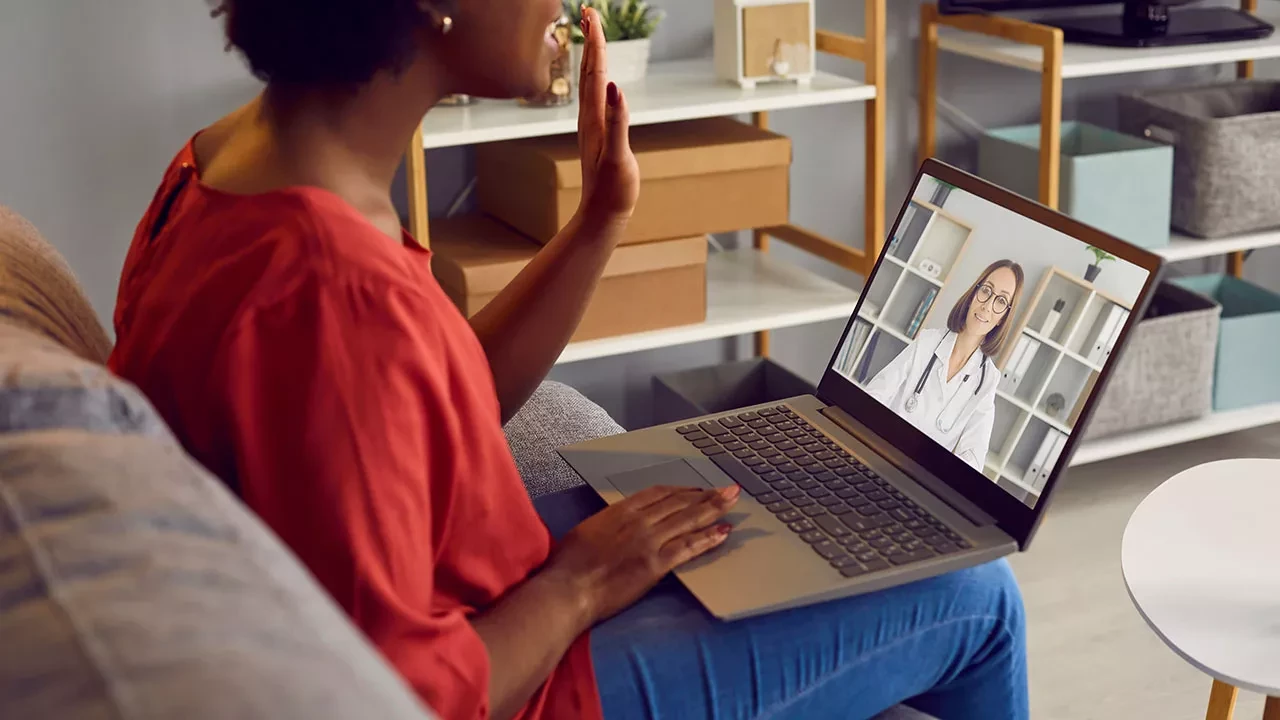 Woman talking on a laptop with a medical provider