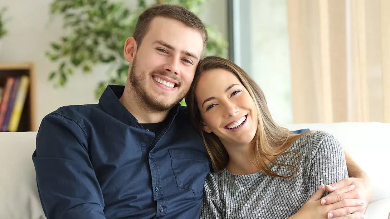 Smiling happy couple on a couch