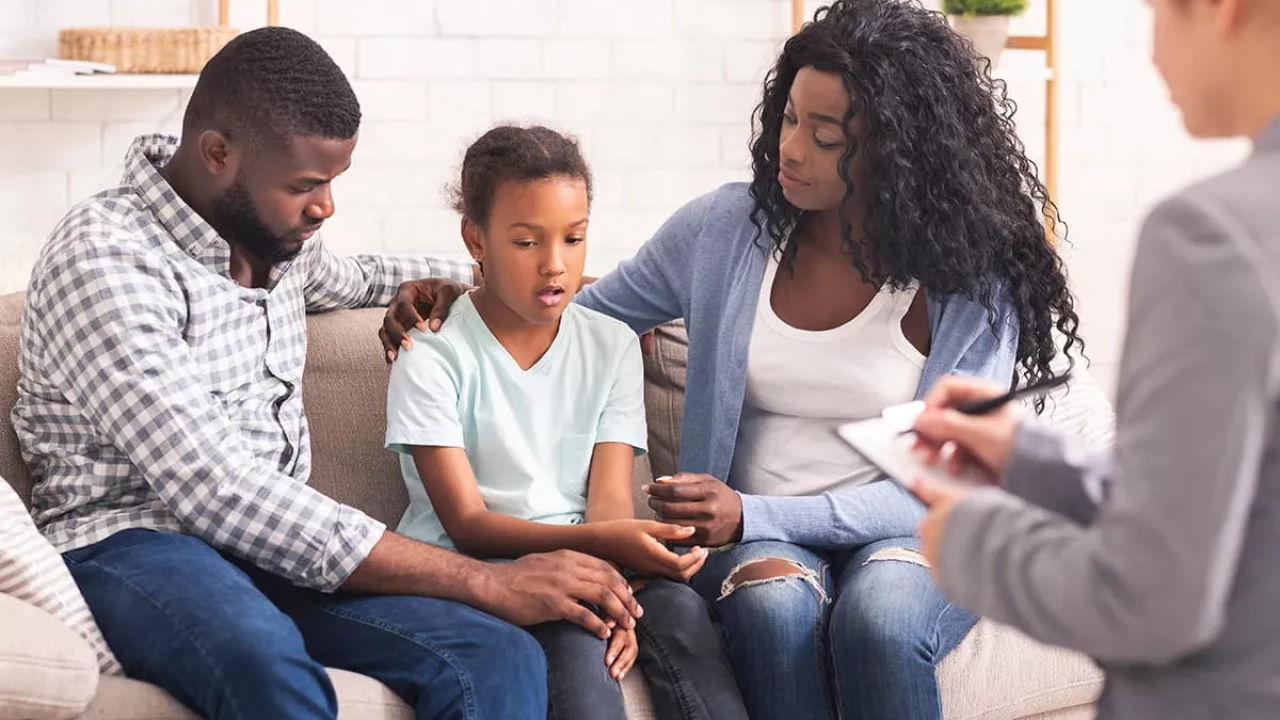 Mom & dad with their daughter at a family counseling session
