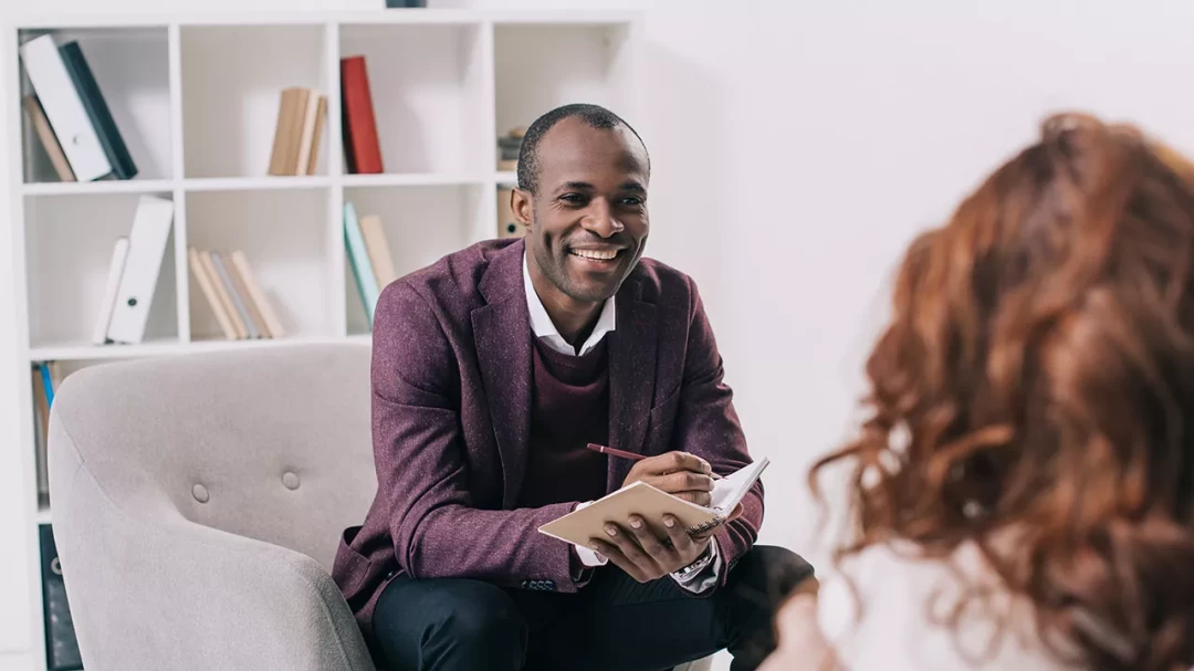 Therapist taking notes during a session
