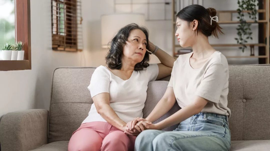 Mother and daughter sitting together having a serious discussion