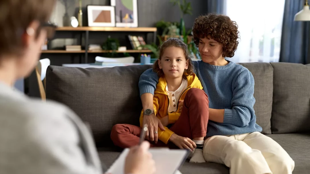 Mother comforting her child during therapy session