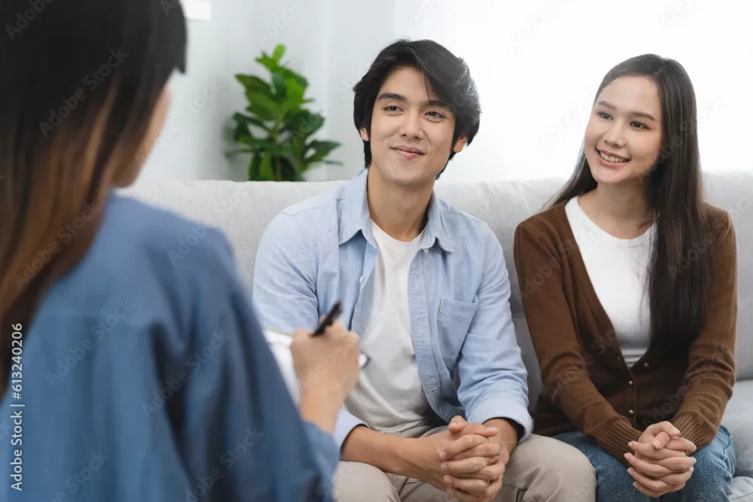 Smiling couple talking with a therapist