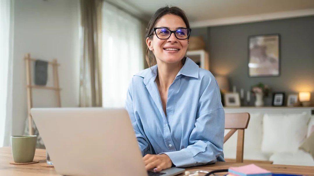 Smiling woman using a laptop