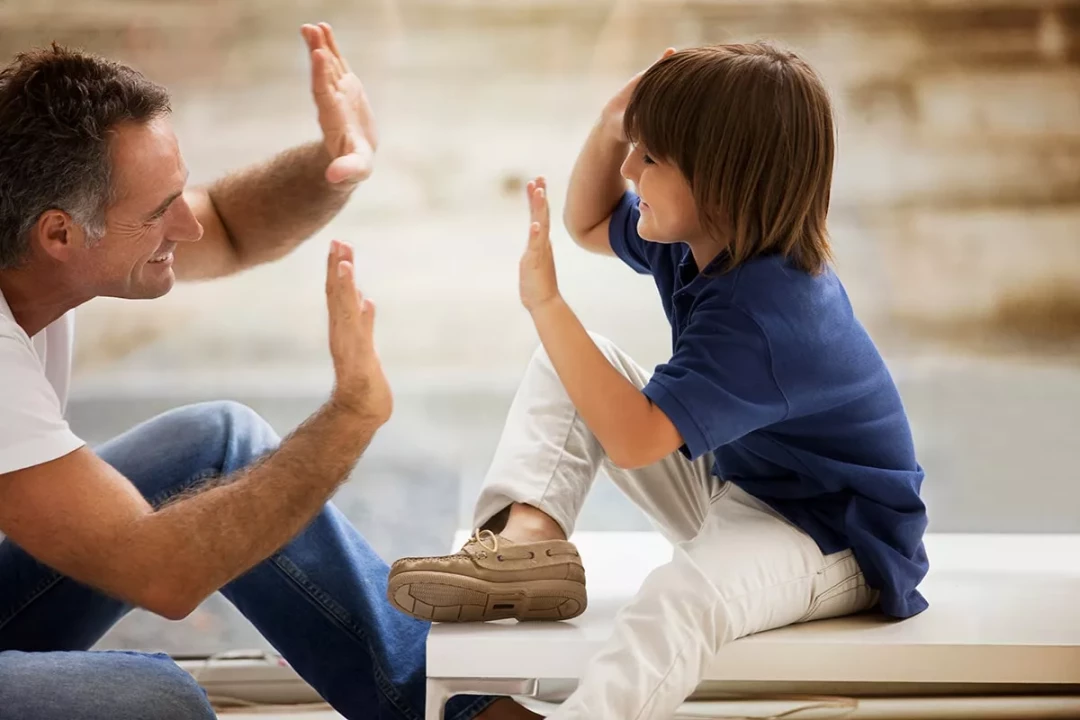 dad giving child high fives