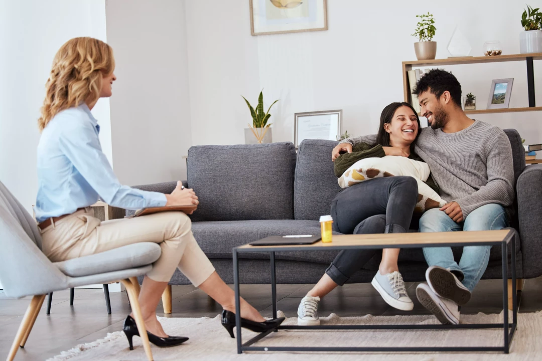 Couple sitting on the couch talking to therapist